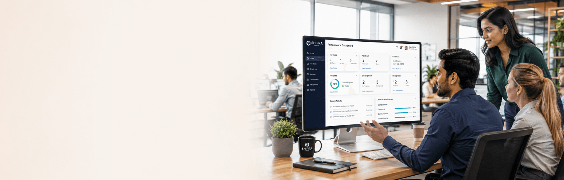A performance dashboard on a monitor with colleagues reviewing it together